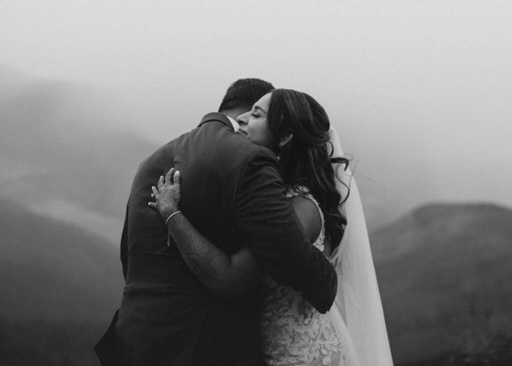 Bride and Groom's hugging atop Vail Mountain in CO.
