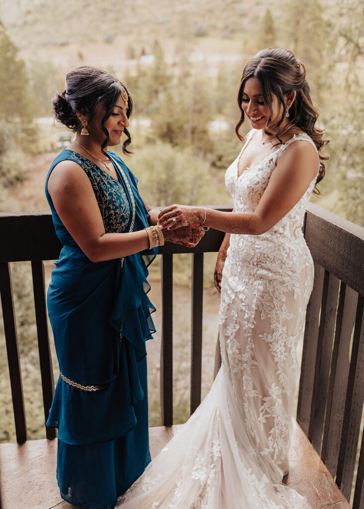 Bridesmaid helping bride put on bracelet in Vail, CO.