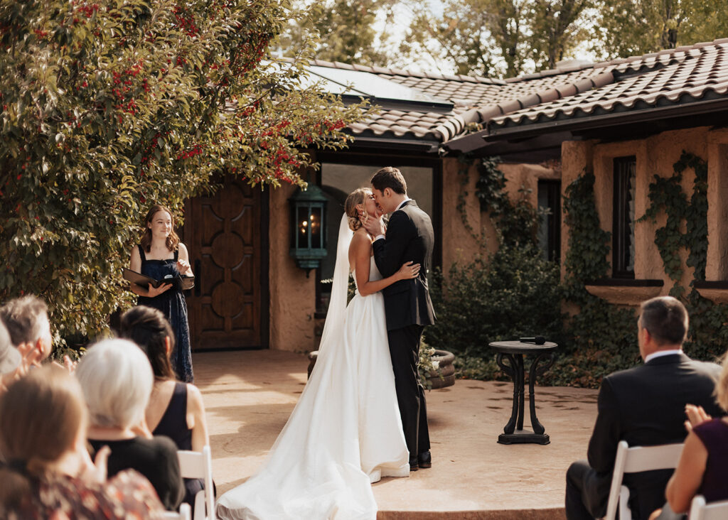 First kiss during wedding ceremony at Villa Parker in Colorado