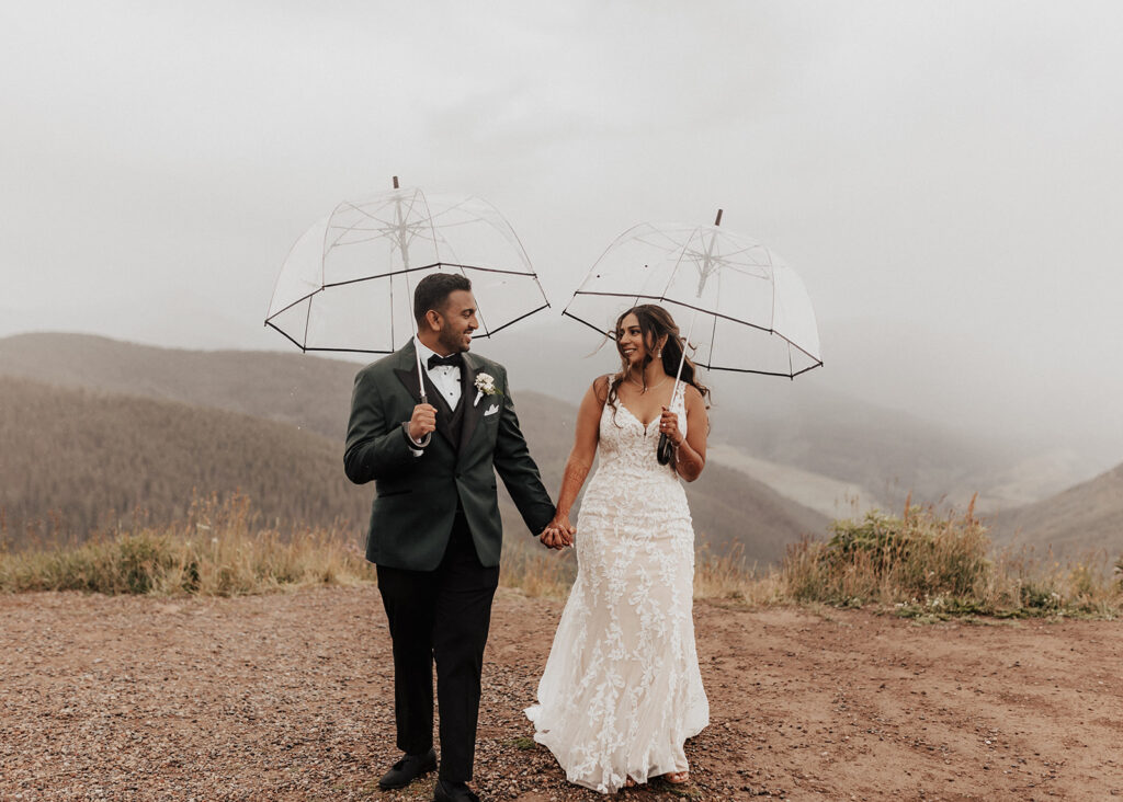 Bride and groom walking atop Vail Mountain in Colorado.