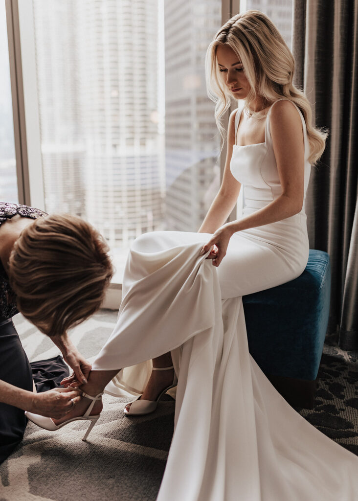 Mom helping bride into shoes at The LondonHouse Chicago