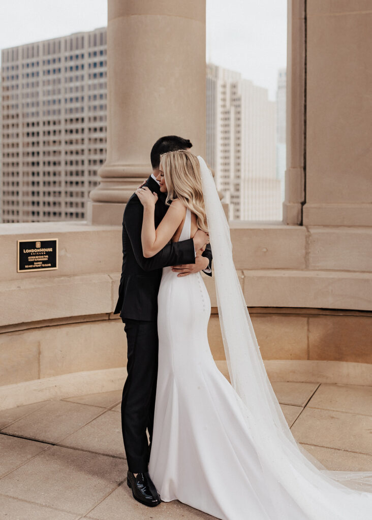 Bride and groom hugging atop The LondonHouse Chicago