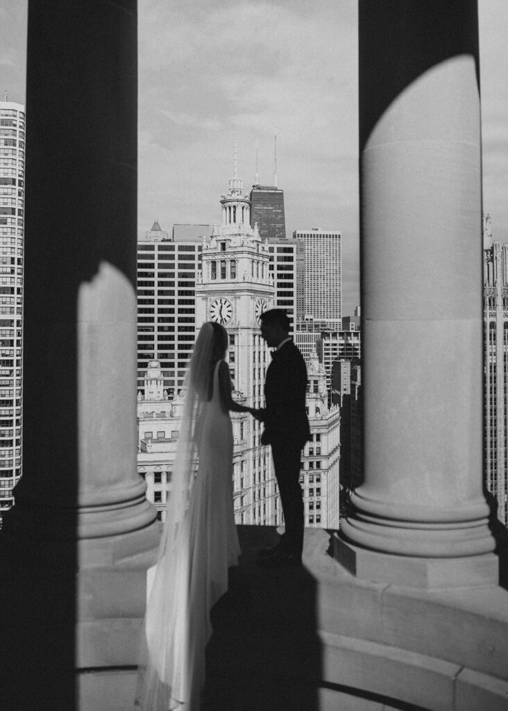 Bride and groom looking out at Michigan Avenue in Chicago, IL