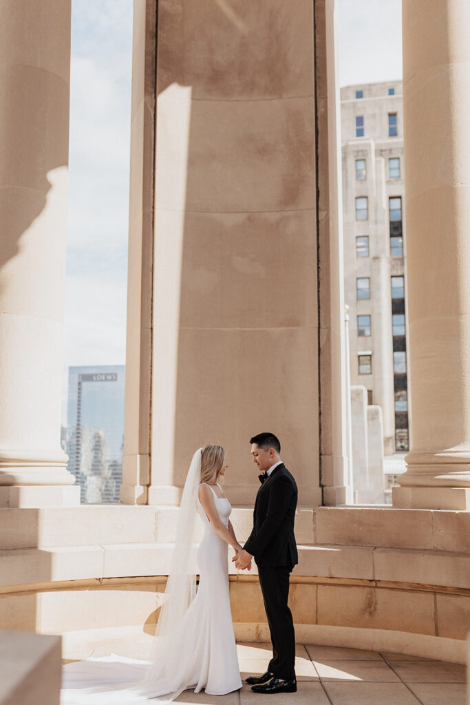 Bride and groom holding hands atop The LondonHouse Chicago