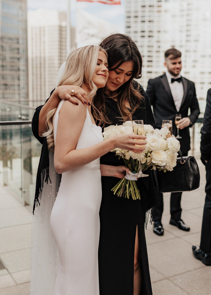 Bride hugs guest after wedding at The LondonHouse Chicago