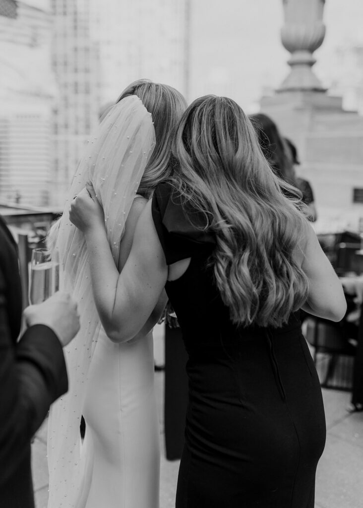 Bride hugs guest after wedding at The LondonHouse Chicago