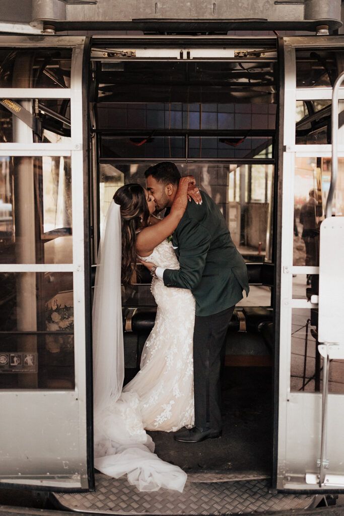 Bride and groom kissing in Vail Mountain gondola.