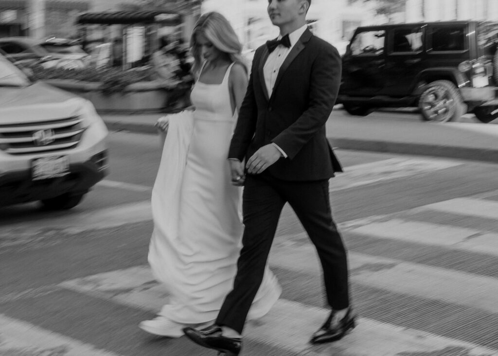 Bride and groom crossing the street on Michigan Avenue in Chicago, IL