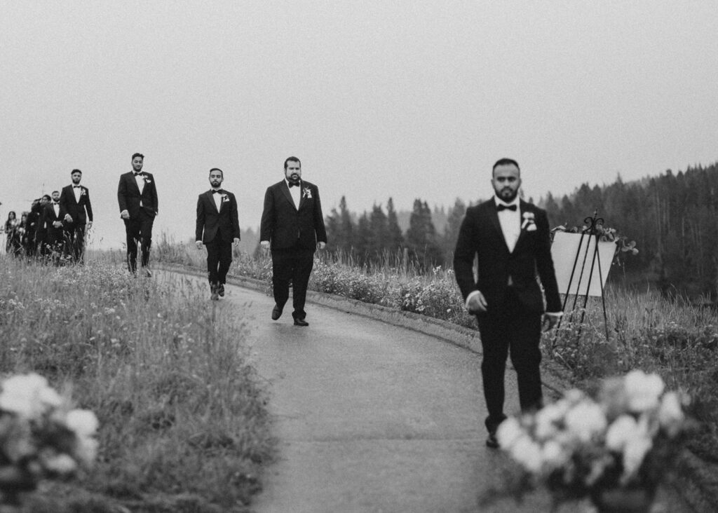 Groomsmen walking down the aisle during wedding in Vail, CO.