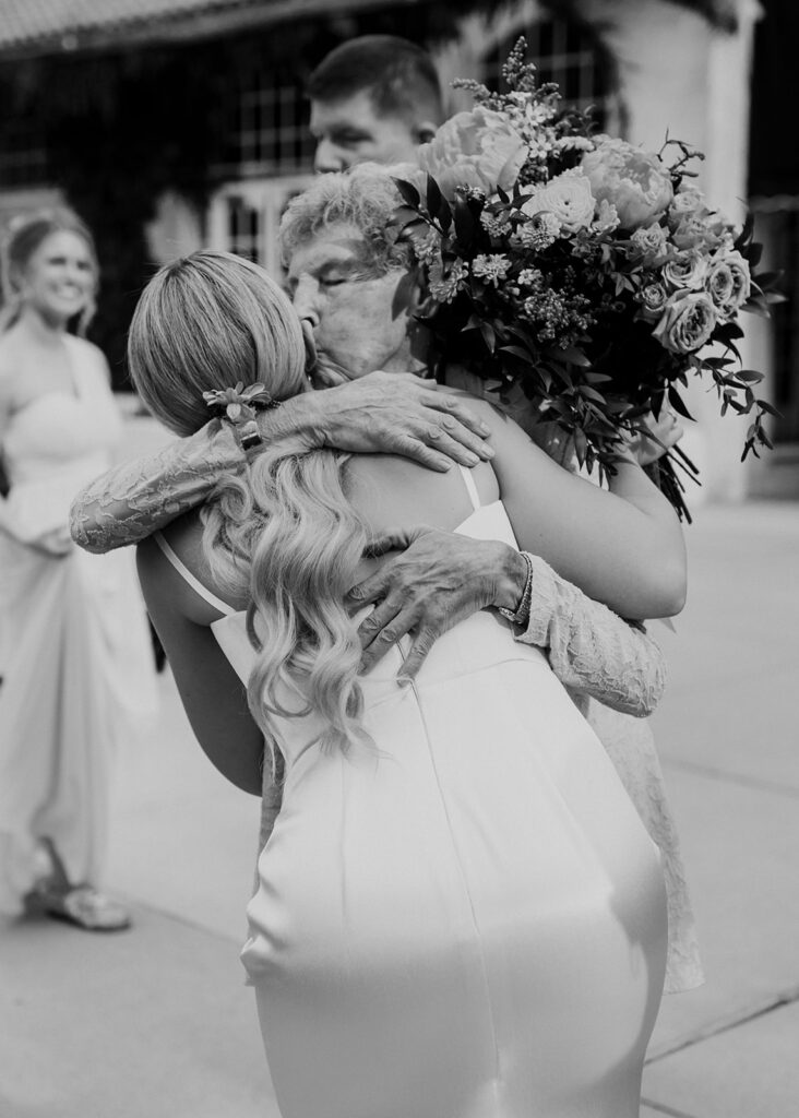 Bride hugging grandma after wedding ceremony