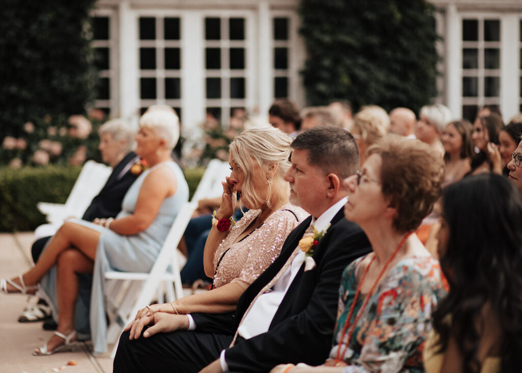 Emotional wedding ceremony in the courtyard of Ravisloe Country Club