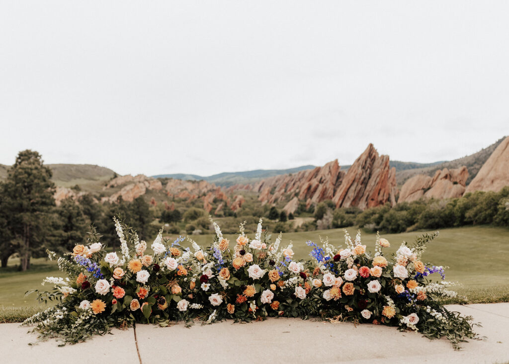 Colorful floral arch for wedding at Arrowhead Golf Course