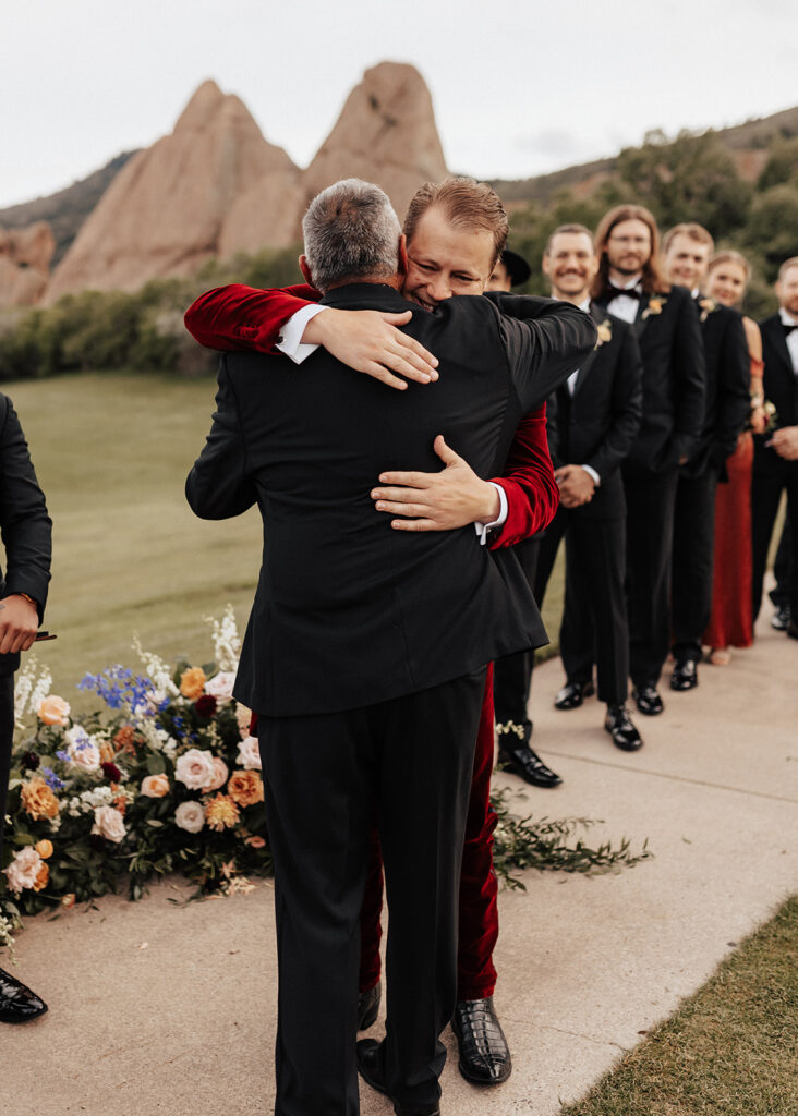 Father hugging groom at Arrowhead Golf Course wedding