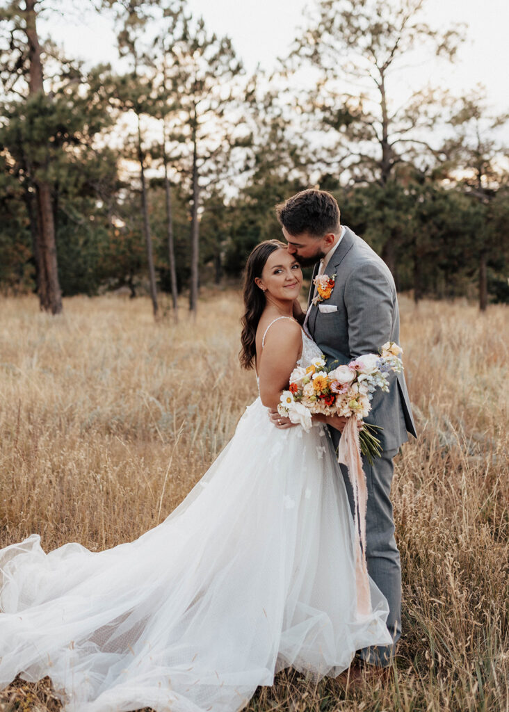 Bride and groom portrait in a golden field in Colorado Springs, CO