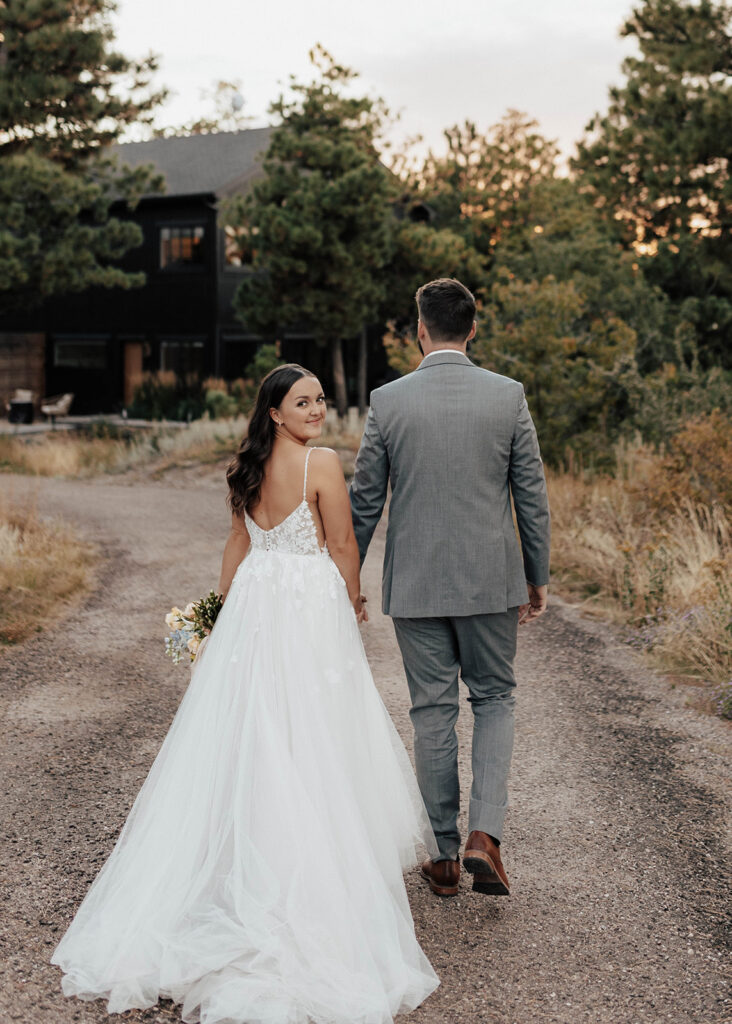 Bride and Groom walking towards The Lofthouse in Colorado Springs, CO