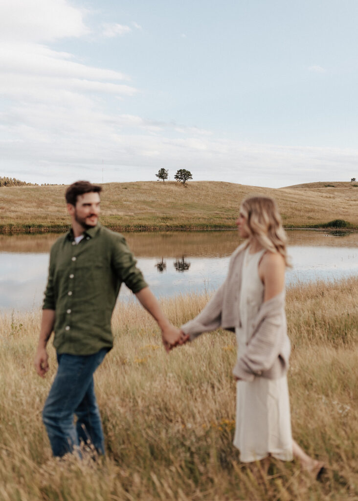 Engagement portrait with pond in Boulder, CO