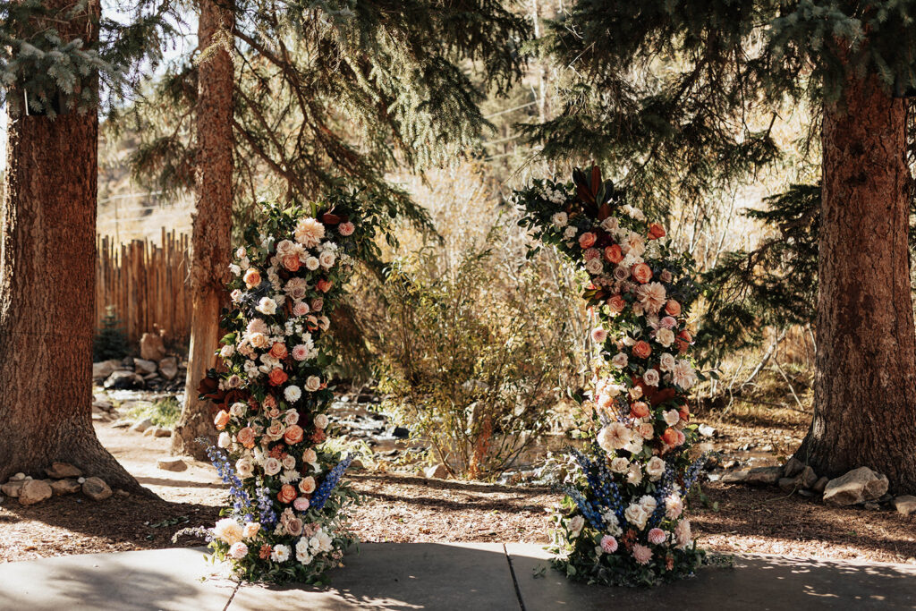 Floral arch for wedding ceremony at Blackstone Rivers Ranch in Idaho Springs, CO.