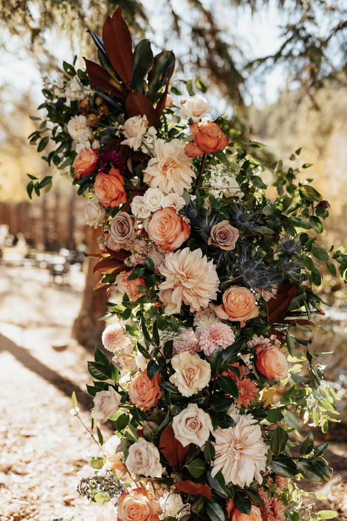 Floral arch for wedding ceremony at Blackstone Rivers Ranch in Idaho Springs, CO.