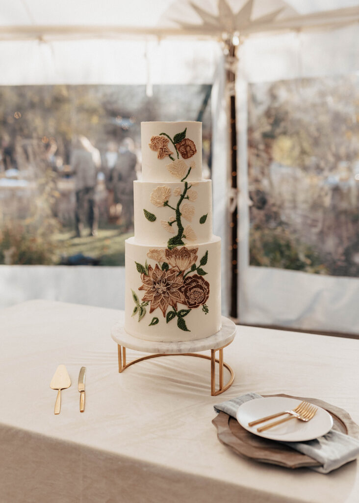 Ornate cake at wedding reception at Blackstone Rivers Ranch in Idaho Springs, CO.