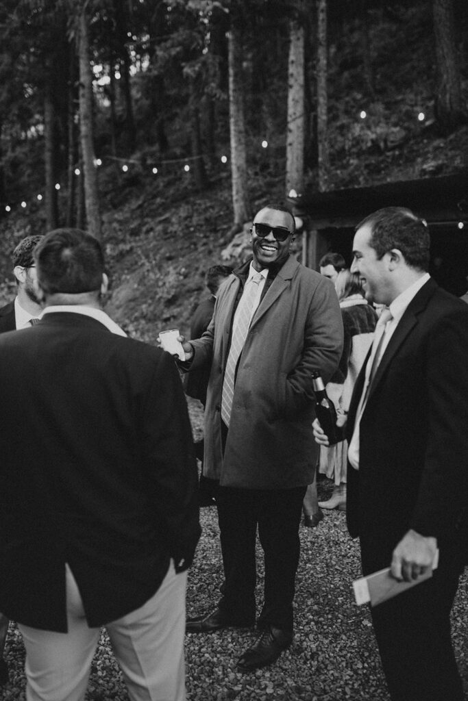Wedding guest laughing during cocktail hour at Blackstone Rivers Ranch.