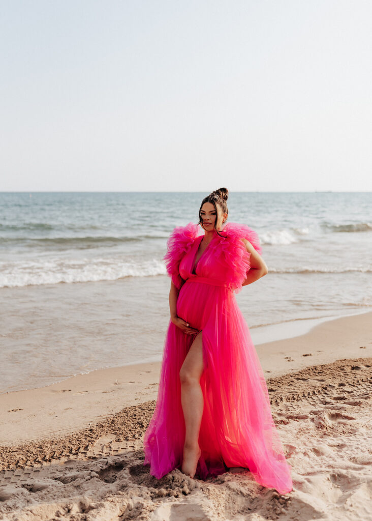 Pregnant woman posing on the beach for maternity photos in Chicago.