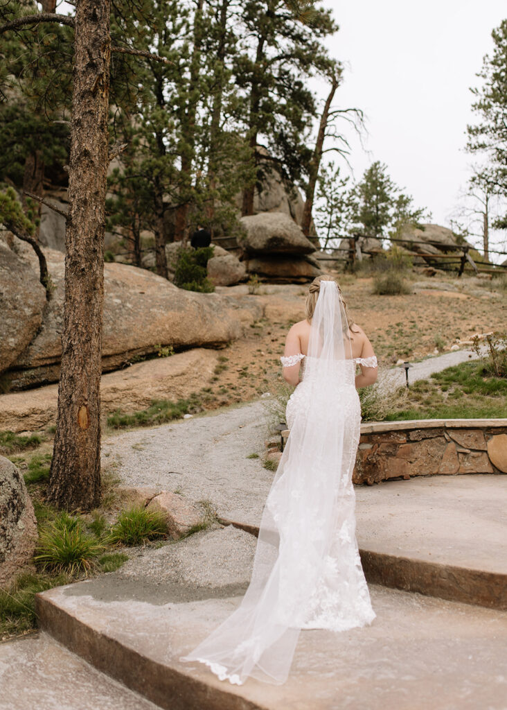 Bride walking to first look at Black Canyon Inn in Estes Park, CO