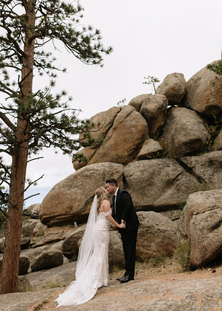 Bride and groom kissing at Black Canyon Inn in Estes Park, CO