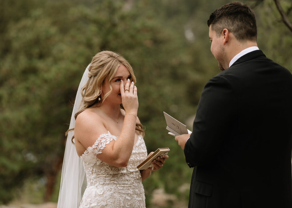 Bride shedding a tear during vows with groom at Black Canyon Inn 