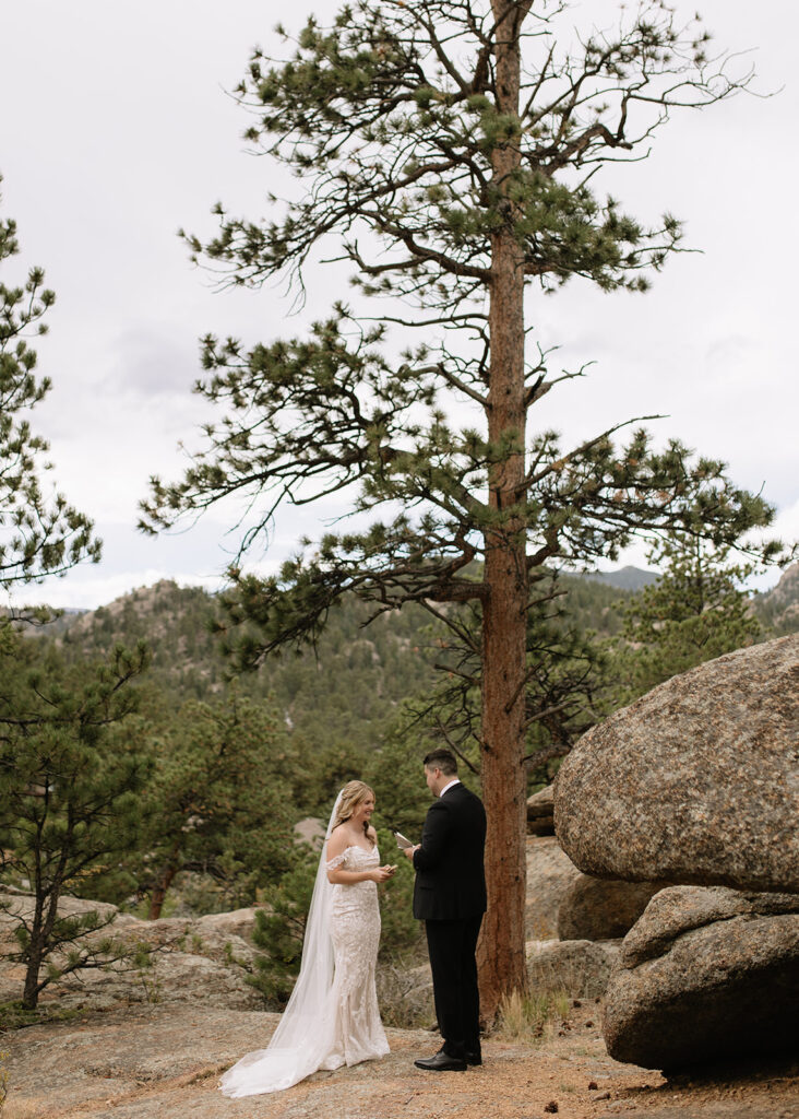 Bride and groom reading vows at Black Canyon Inn in Estes Park, CO