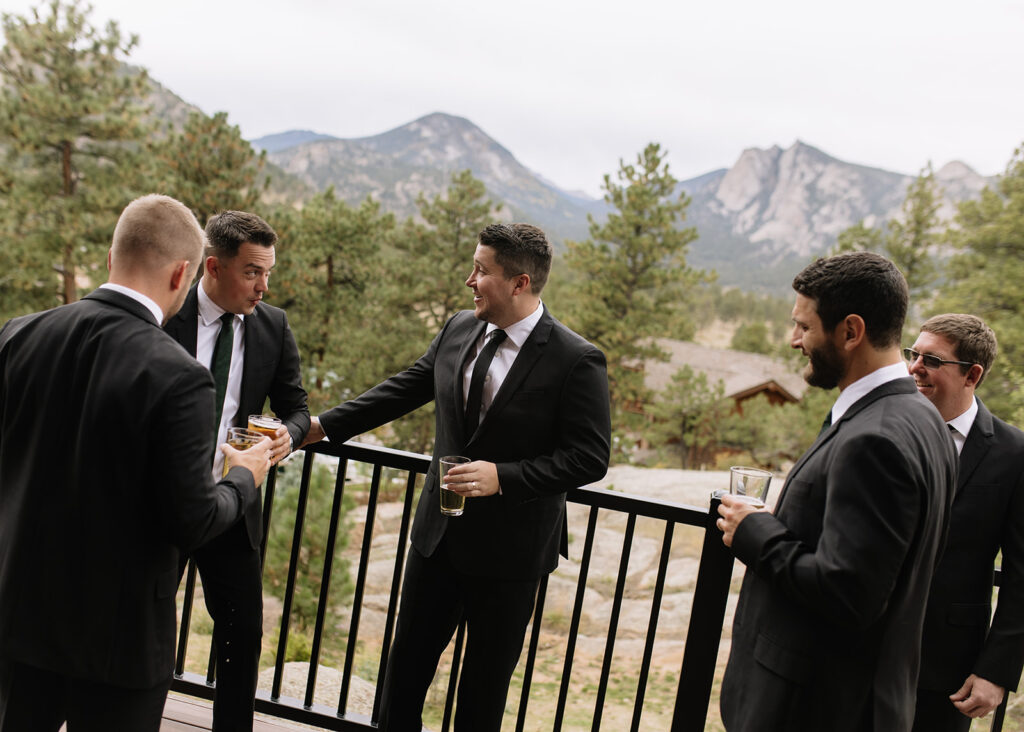 Groomsmen hanging out on the balcony of Black Canyon Inn in Estes Park, CO