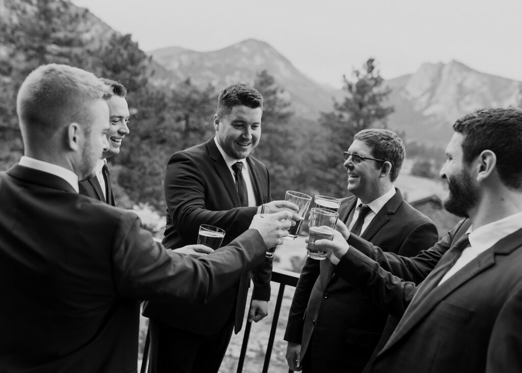 Groomsmen hanging out on the balcony of Black Canyon Inn in Estes Park, CO