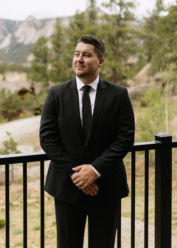 Groom on the balcony of Black Canyon Inn in Estes Park, CO